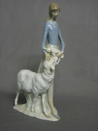 A Lladro figure of a standing lady with sheep and lamb, the base marked Lladro Made in Spain, 12"