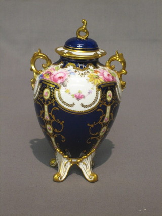 A  Royal Crown Derby blue glazed porcelain oval  twin  handled urn and cover with gilt banding and floral decoration 5"