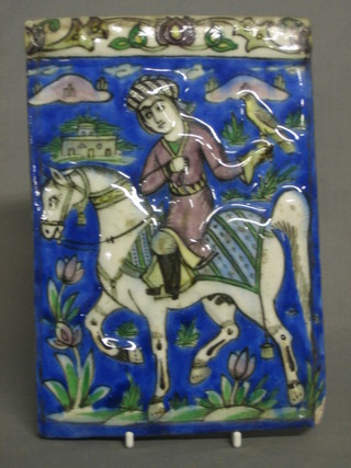 A  Persian  tile decorated horseman and falcon 9" x  6"  (chip  to right hand corner)