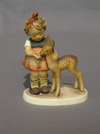 A Hummel figure of a standing girl with doe 5"