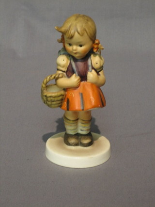 A Hummel figure of a standing girl with haversack and basket 5"