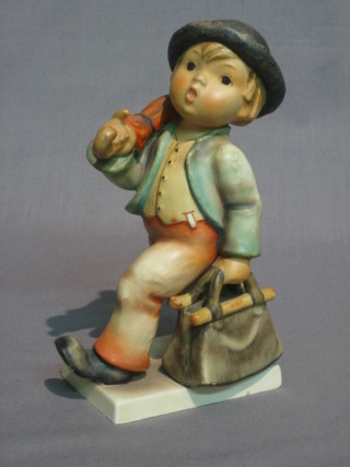 A  Hummel  figure of a standing boy with case and  umbrella  6"