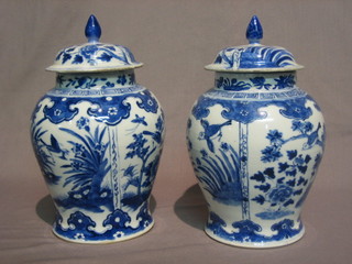 A  pair  of 19th Century Oriental blue and  white  porcelain  urns and  covers,  the base with 4 figure character mark  (restored)  7"
