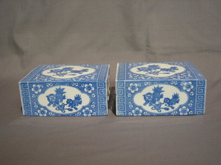 A  pair of 19th Century blue and white pottery pillows  decorated dogs of fo 6"