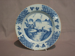 A Delft pottery plate decorated a figure and a house 9"  (cracked)
