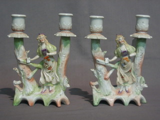 A   pair   of  19th  Century  porcelain  twin   light   candelabrum supported by a figure of a lady by a gate (1f) 8"