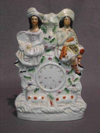 A  19th Century Staffordshire flat back figure group in  the  form of a clock supported by figures 10" (f and r)