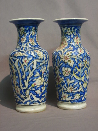 A pair of Persian style pottery club shaped vases 11" (1 with chip to rim)