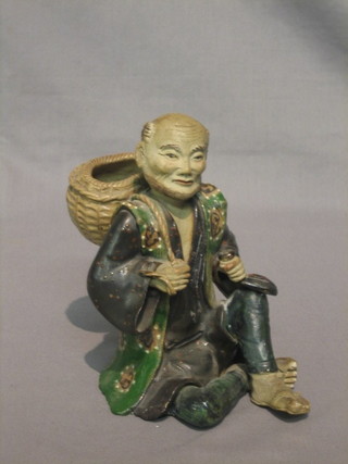 A  19th Century Oriental pottery figure of a seated gentleman  6"