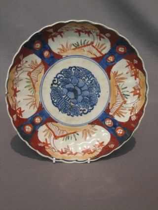 A 19th Century circular Japanese Imari porcelain plate with lobed body and panelled decoration 9"  (crack to rim)