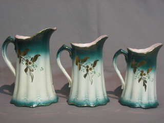 A set of 3 graduated 19th Century green glazed pottery jugs  with  gilt decorated