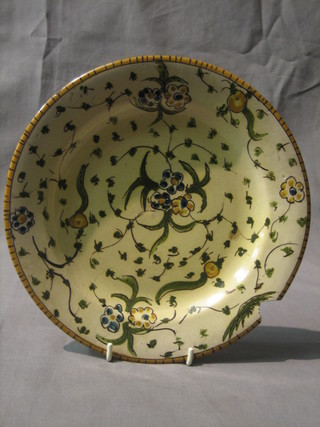 An  18th/19th  Century  Delft style plate with  green  and  yellow floral decoration, the reverse with bird mark, 9" (f and r)