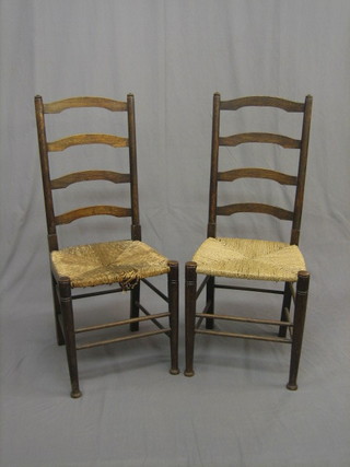 A pair of elm ladder back chairs with woven rush seats