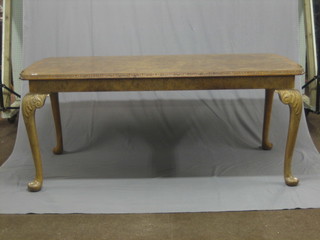 A  Queen  Anne style walnut dining table with  crossbanded  top, raised on carved cabriole supports 72"