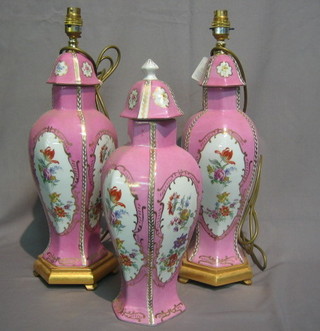 A pair of porcelain table lamps together with a matching urn  and cover all with puce and gilt decoration