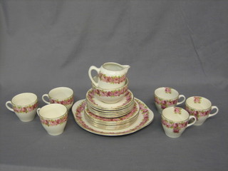A 21 piece Royal Doulton floral patterned tea service  comprising 9" circular twin handled plate, 6 tea plates 6 1/2", cream jug  and  sugar  bowl,  6  cups and 6 saucers (1  cracked),  all  with  floral decoration and the base marked DE5533