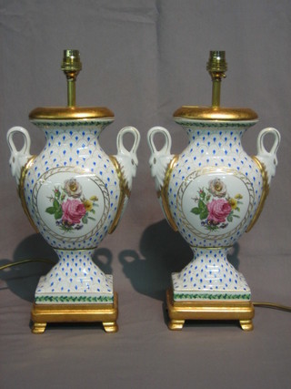 A pair of porcelain table lamps in the form of twin handled urns  with floral decoration 14"