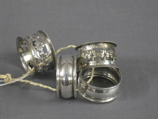 A pair of silver napkin rings and a pair of silver plated napkin rings