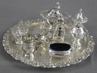 A circular silver plated salver 10", a silver plated mustard pot matching pepper pot, a Ronson table lighter, a 3 piece silver plated condiment set and a spirit level