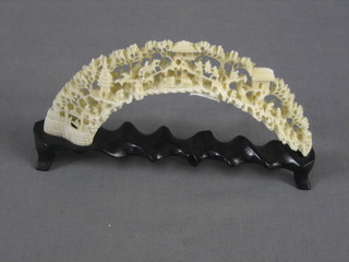 A section of carved ivory tusk, carved figures and buildings 7 1/2"