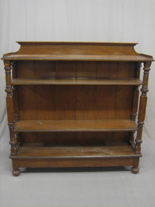 A Victorian walnut 4 tier buffet, raised on turned and fluted supports 53"