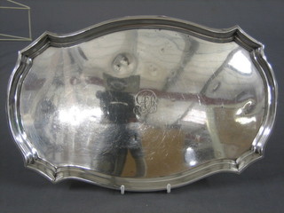An oval silver dressing table tray, London 1917, 13" wide, 17 ozs