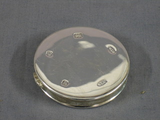 A circular silver compact 3"