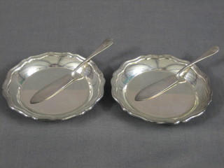 2 circular silver butter dishes with bracketed borders 3 1/2" together with 2 matching knives
