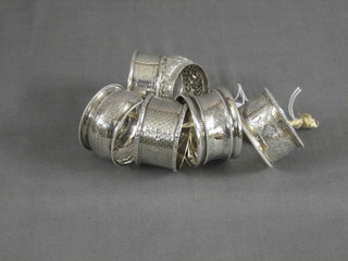 5 silver napkin rings and 1 other
