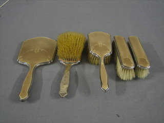 An Art Deco silver and brown enamelled 5 piece dressing table set comprising hand mirror, pair of hair brushes and pair of clothes brushes, Birmingham 1936