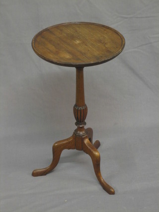 A 19th/20th Century circular mahogany wine table, raised on pillar and tripod supports 12"