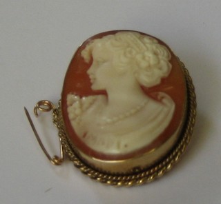 A shell carved cameo portrait brooch signed Inadi and contained in a gilt metal brooch/pendant mount