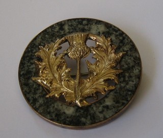 A lady's gilt metal brooch set polished granite decorated a thistle by Jamieson of Aberdeen