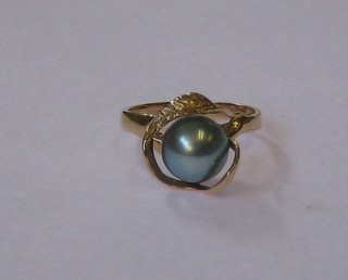 A 14ct gold dress ring set a black pearl