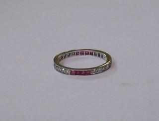 An 18ct white gold diamond and ruby eternity ring