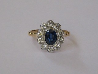 A lady's 18ct yellow gold dress ring set an oval cut sapphire surrounded by 10 diamonds