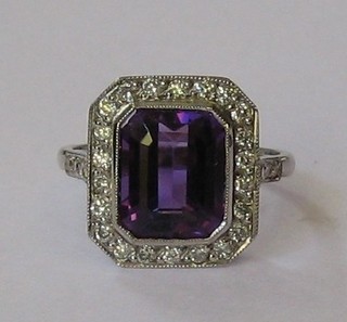 A lady's 18ct white gold dress ring set a rectangular cut amethyst surrounded by numerous diamonds