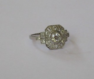 A lady's white gold dress ring set a circular diamond surrounded by numerous diamonds, approx 0.66ct