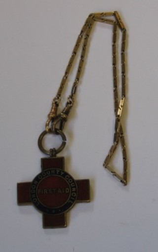 A gilt metal and enamel London County Council first aid badge hung on a gilt chain