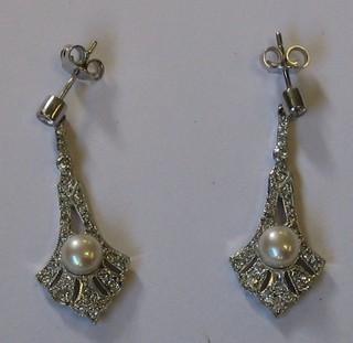 A pair of lady's pierced white gold earrings set pearls and diamonds