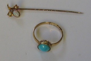 A gold dress ring set a cabouchon cut turquoise together with a gold stick pen set demi-pearls and an opal