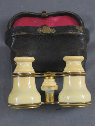 A pair of ivory cased and gilt metal opera glasses