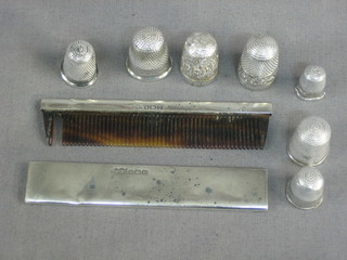 A silver cased comb Birmingham 1928, 3 silver thimbles and 4 others