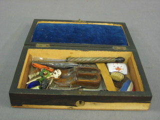 A rosewood box containing a pair of model slippers, a silver hoof shaped brooch and other items etc