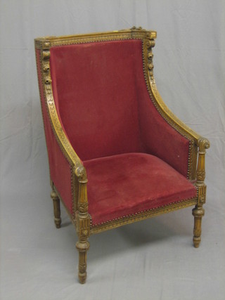 A 19th/20th Century Continental carved walnut show frame tub back chair upholstered in red material, raised on turned and fluted supports
