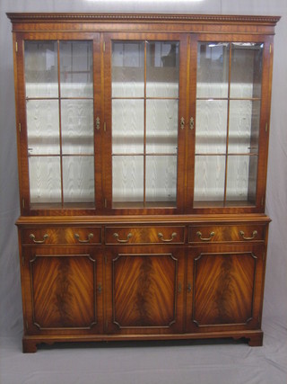 A Georgian style mahogany cabinet on cabinet, the upper section with moulded and dentil cornice, the interior fitted a glazed shelf enclosed by astragal glazed panelled doors, the base fitted 3 long drawers above a triple cupboard, raised on bracket feet 59"