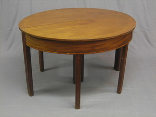 A Georgian mahogany D end dining table with 2 extra leaves, raised on square supports