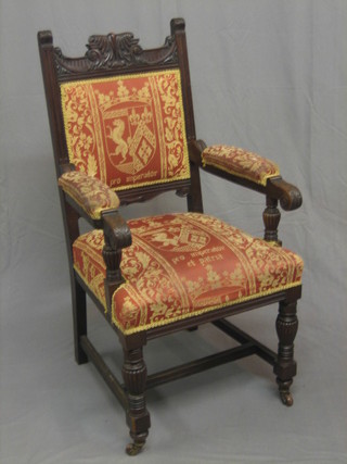 An Edwardian carved walnut open arm carver chair upholstered in tapestry material
