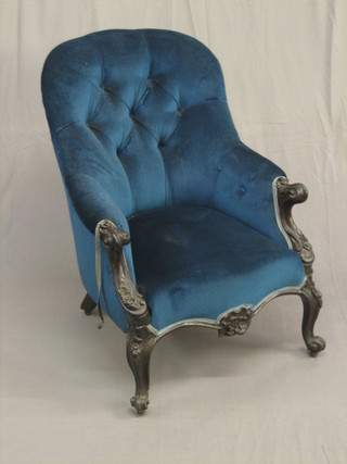 An Edwardian ebonised show frame armchair upholstered in blue material