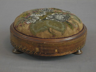 A Victorian circular mahogany footstool with bead work seat, raised on 3 bun feet 10"